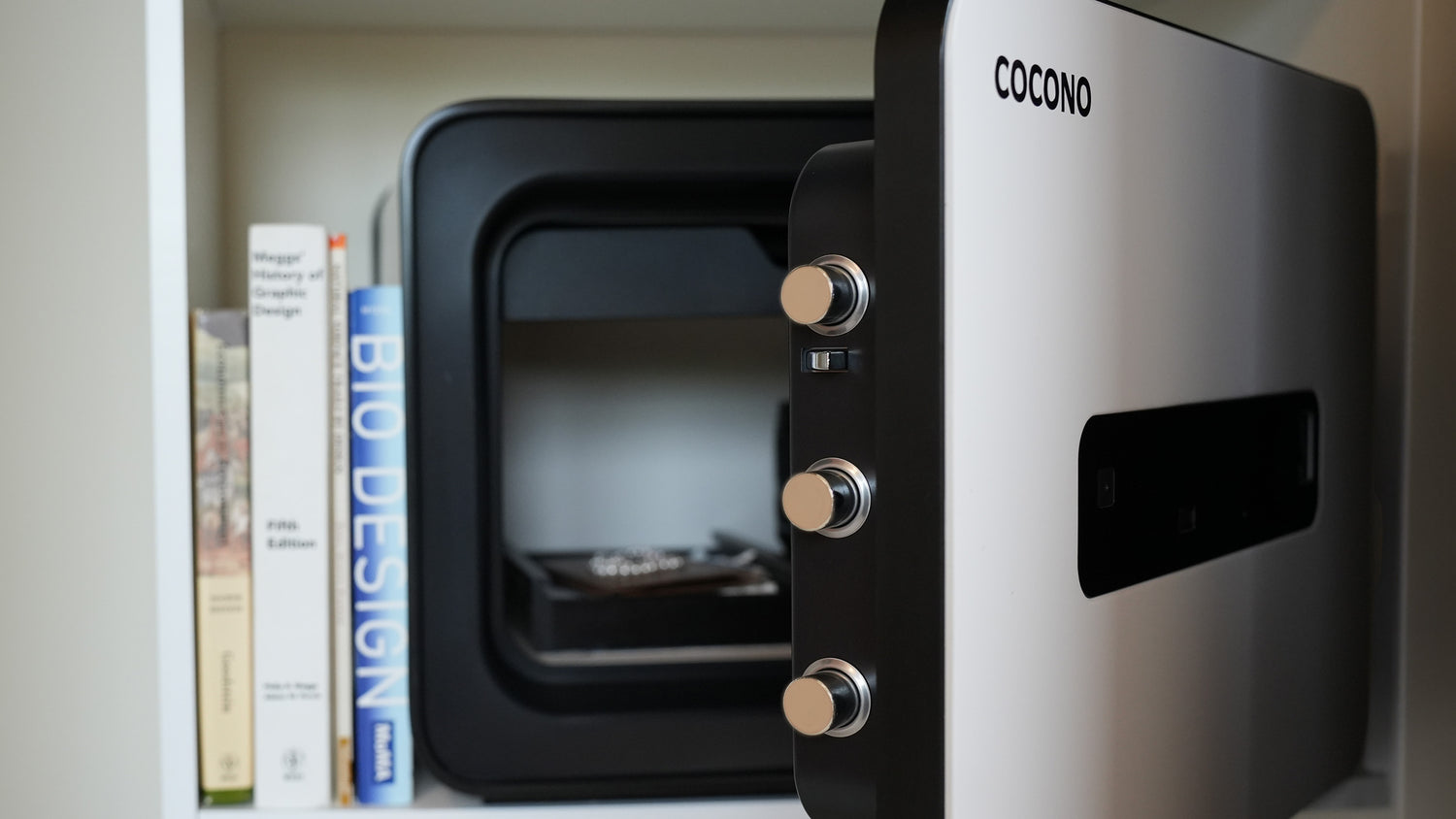 Open Cocono 20 Classic small fireproof home safe in Ivory showing bolts.