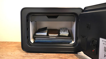 Cocono Classic 20 Small Fireproof Safe showing what fits: binder, folders, laptop, passports, checkbook, cash