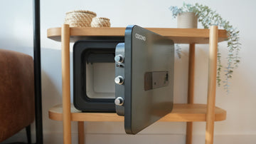 Cocono 20 Classic Small Fireproof Safe in Olive in a modern living room.