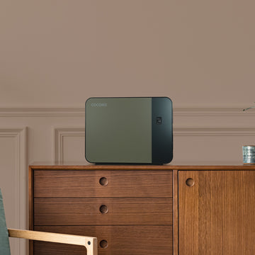 Cocono Chroma 15 Mini Fireproof Safe in Turtle, luxury safe on an end table.