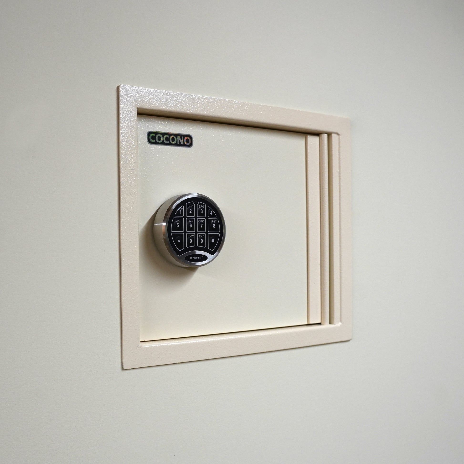 Cocono wall safe hidden in wall, shown in Ivory with U.L. electronic lock