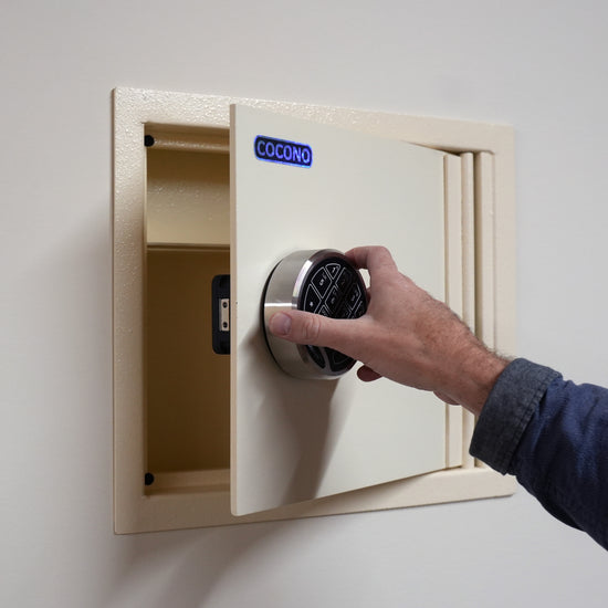 Cocono wall safe hidden in wall, shown in Ivory with U.L. electronic lock